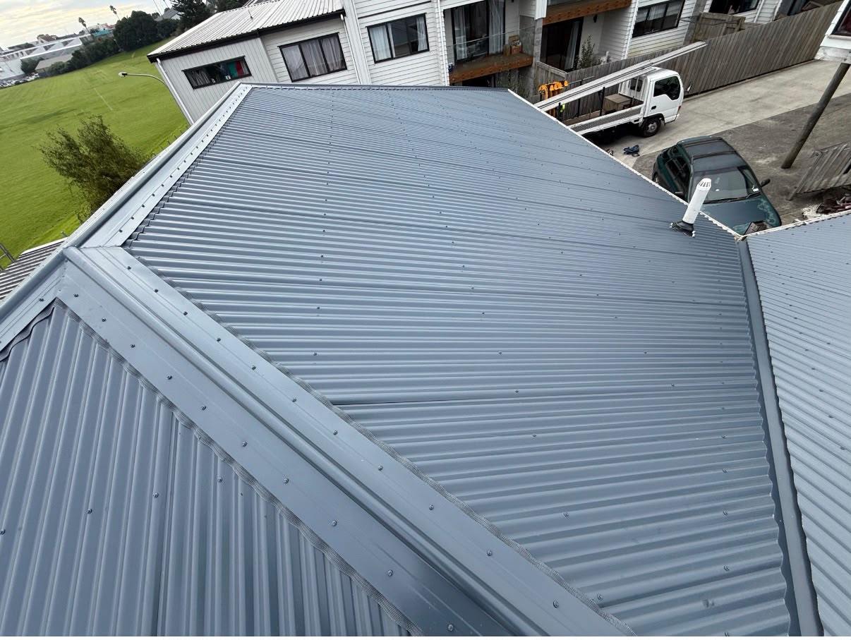 A finished long-run roof with clean hip and ridge lines