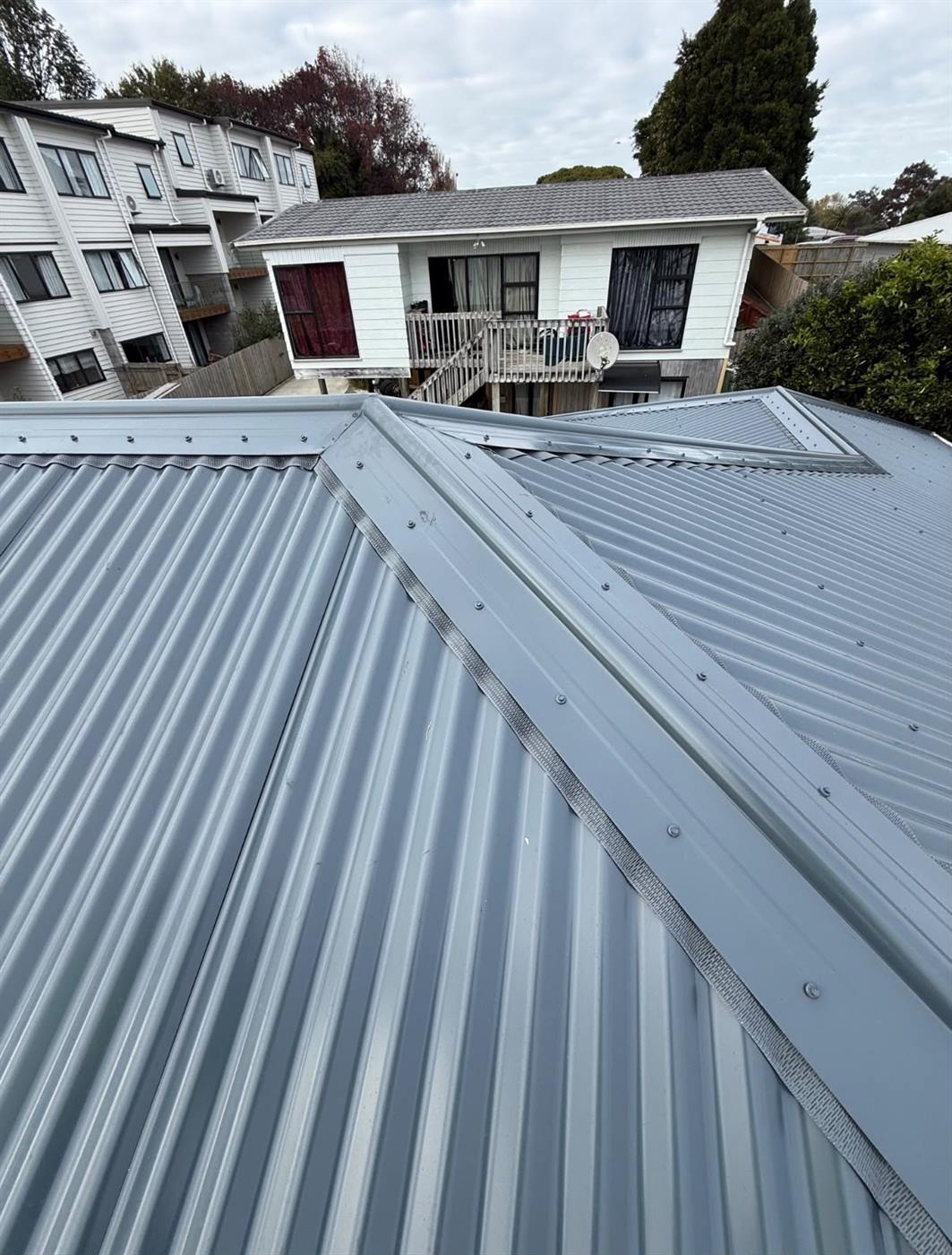 Close view along the ridge of the completed long-run roof